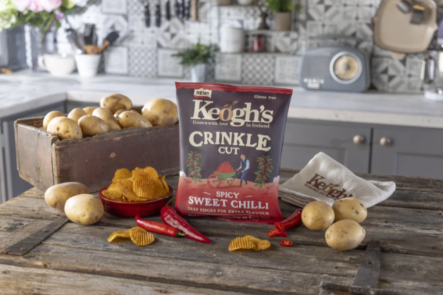 crinkle cut sweet chilli pack on wooden surface with potatoes