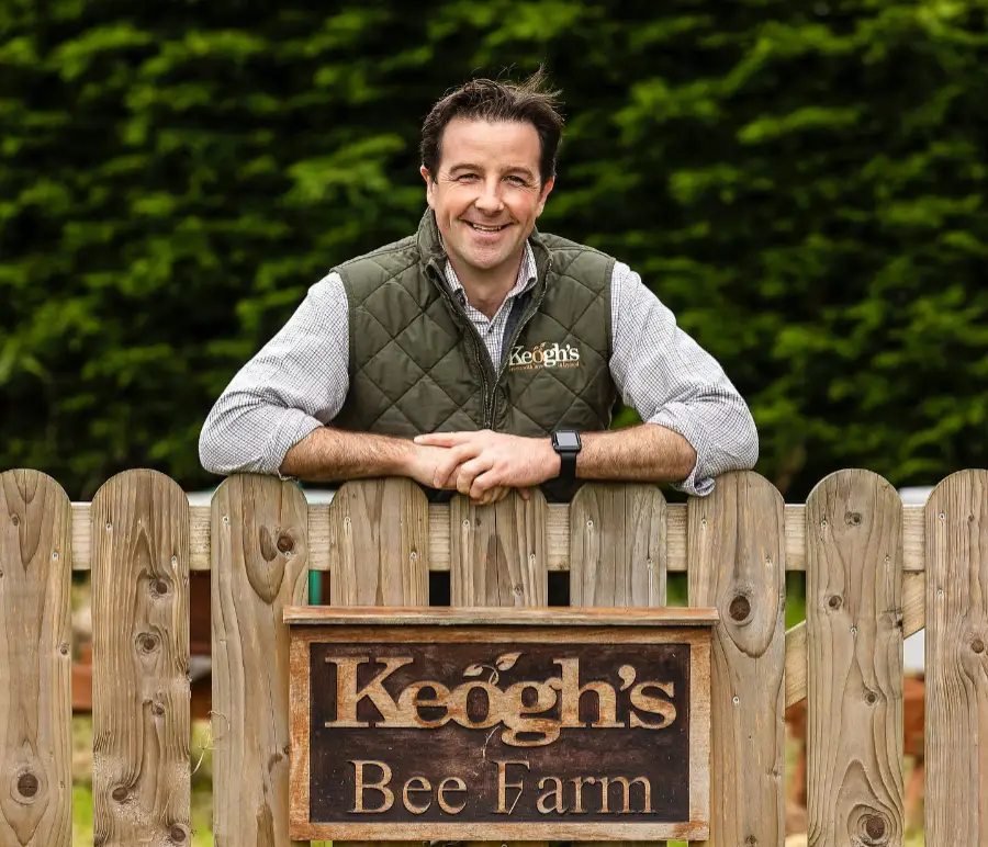 man by keoghs bee farm sign