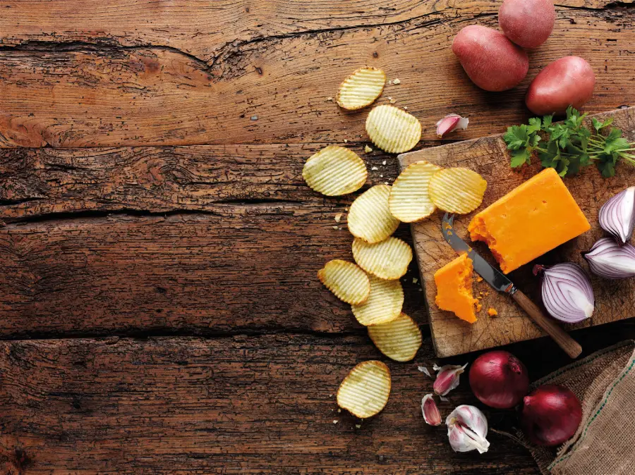 mature irish cheddar and red onion wooden background