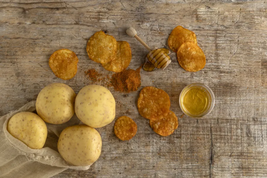 potatoes and honey on wooden board