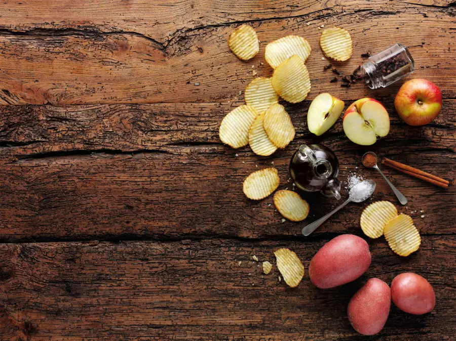 potatoes apples salt pepper wooden background