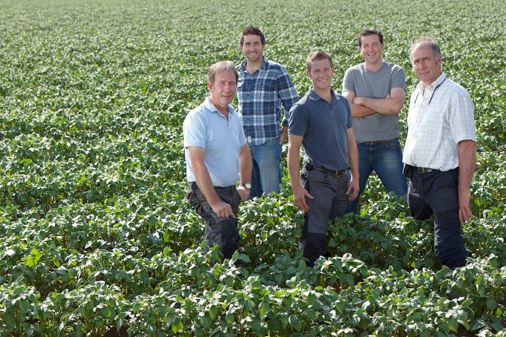 Keoghs Family Standing In Potato crop field.