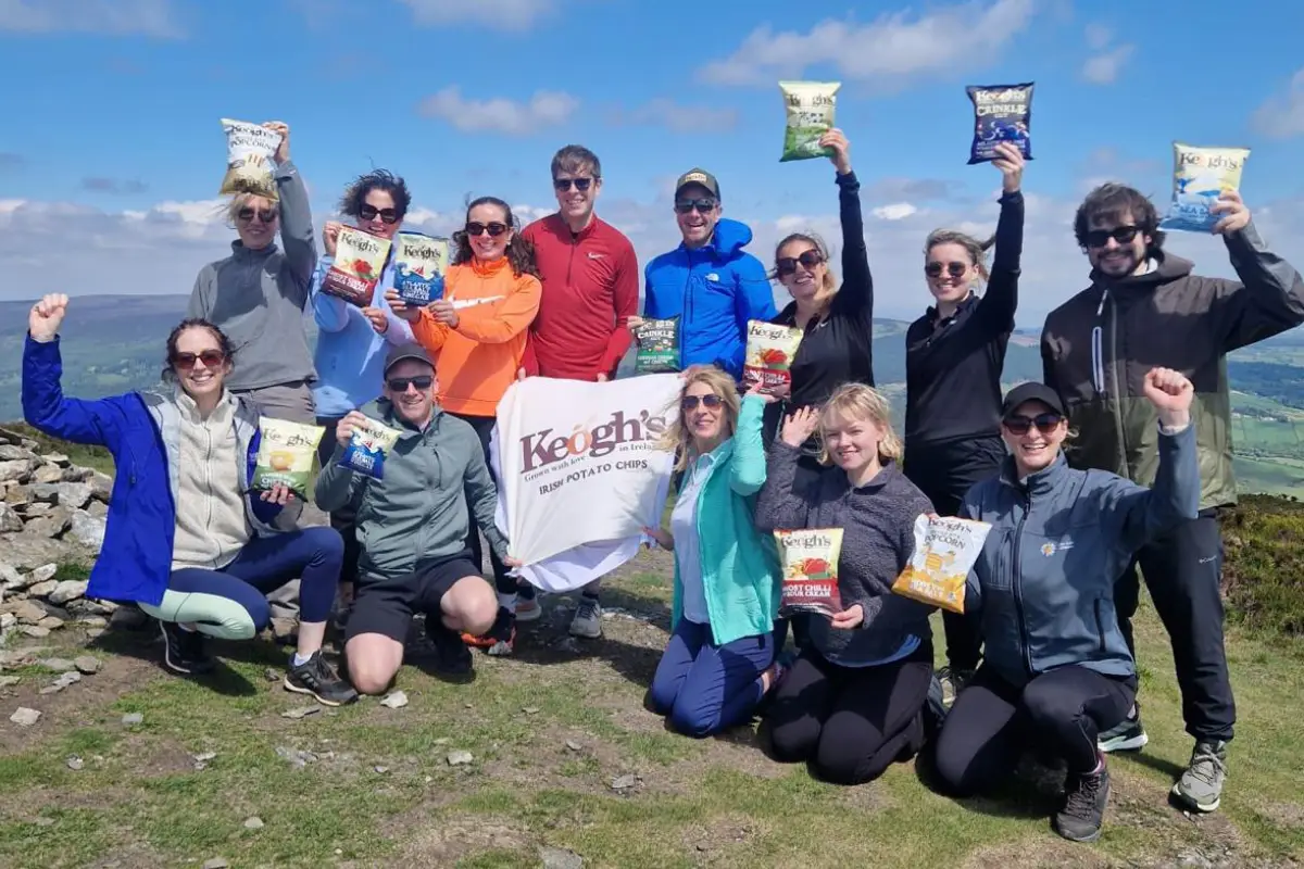 group of people outside holding keoghs crisps range